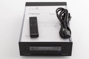 Top of a used Mission 778CDT CD Transport in a Black finish showing Manual, Remote, Batteries and Mains Cable