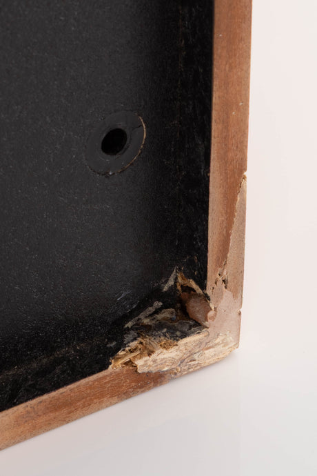 Close up of a used Monitor Audio MA5 Series II Standmount Speakers in a Teak finish showing damage on front right corner