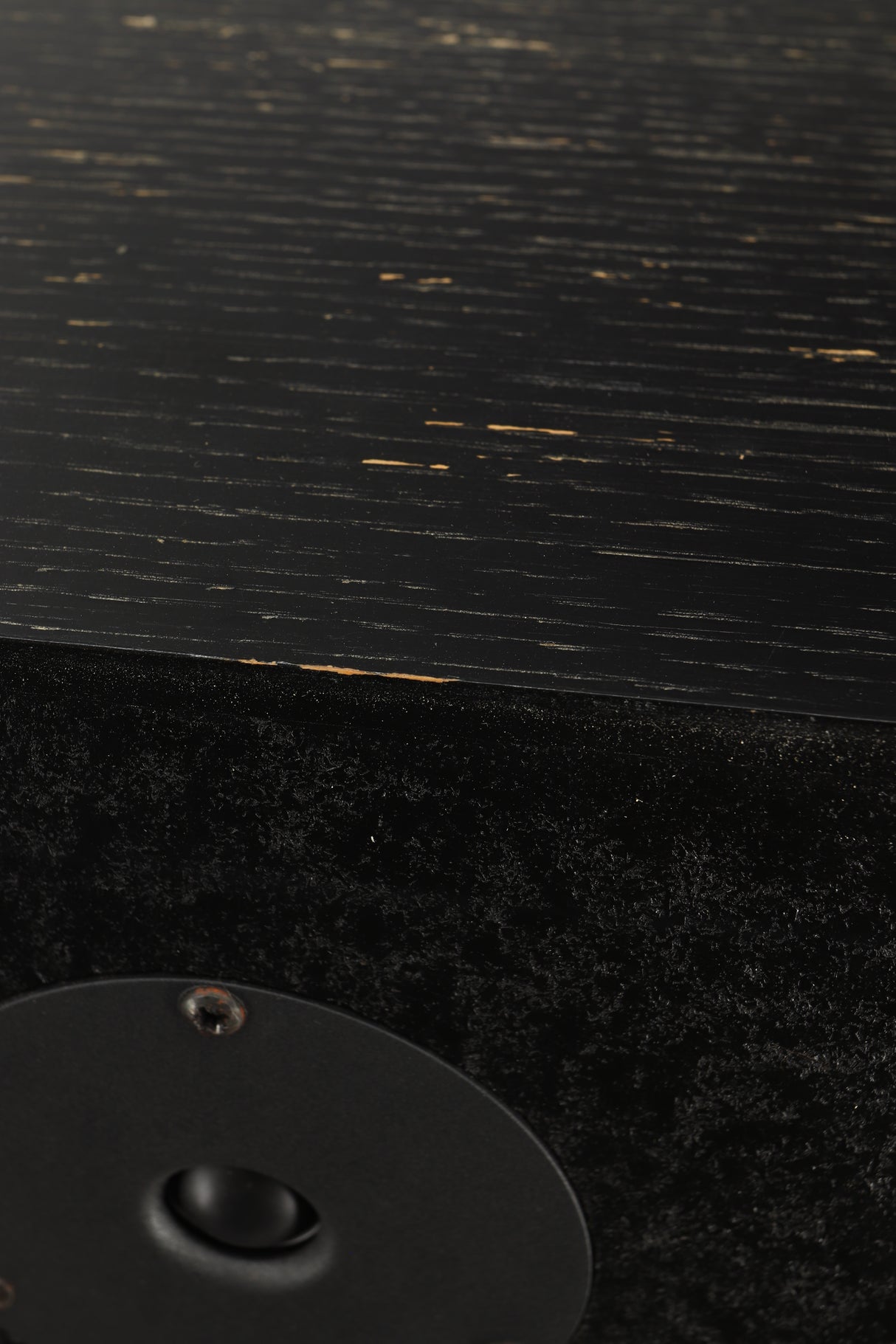 Close up view of a used Monitor Audio R352 Standmount Speakers in Black Ash finish showing chips to the paint work 