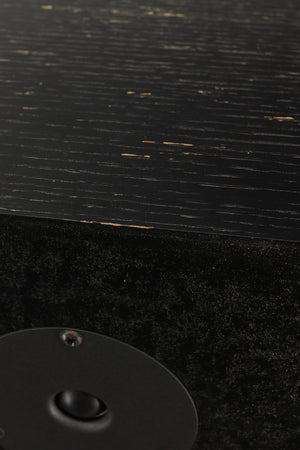 Close up view of a used Monitor Audio R352 Standmount Speakers in Black Ash finish showing chips to the paint work 