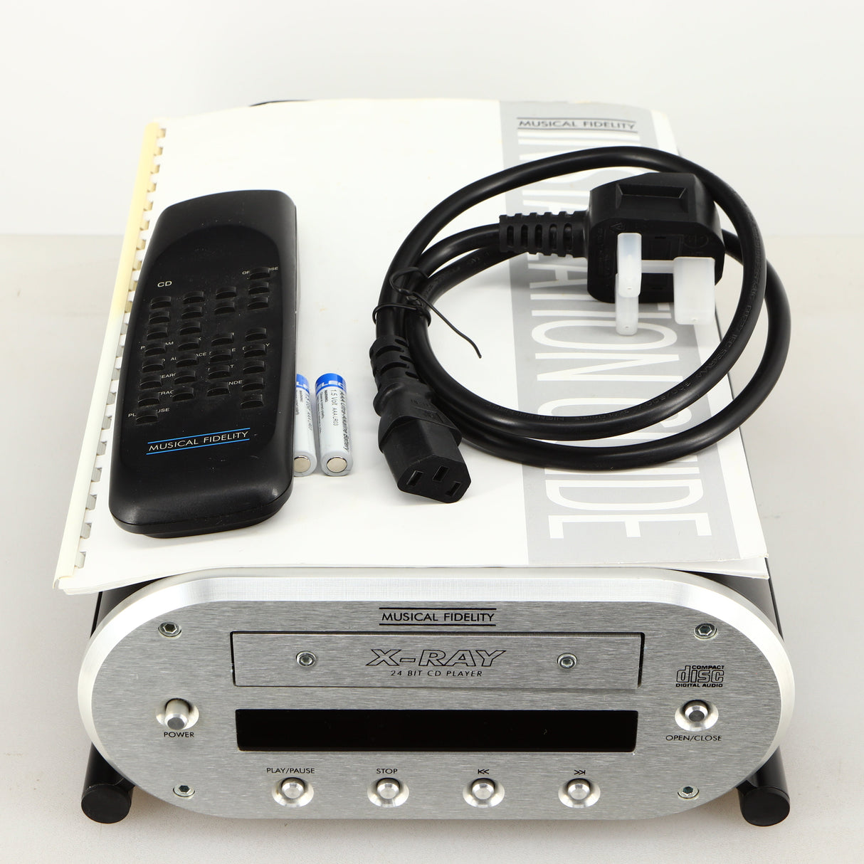 Top of a used Musical Fidelity X-Ray 24 Bit CD Player showing Remote, 2x Batteries, Mains Cable and Manual