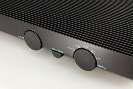 Close up of a used Musical Fidelity B200 Integrated Amplifier in a black finish showing scratching along front edge