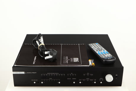 Top of a used Musical Fidelity M6X DAC in a black finish showing Mains Cable, Manual, 2x Batteries and Remote