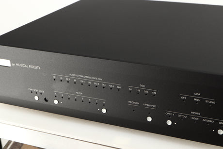 Close up of a used Musical Fidelity M6X DAC in a black finish showing light patch on fascia