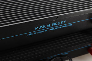 Close up view of a pair of used Musical Fidelity MA50 Class A Monoblock Power Amplifiers in Black finish showing scratching along the back top edge