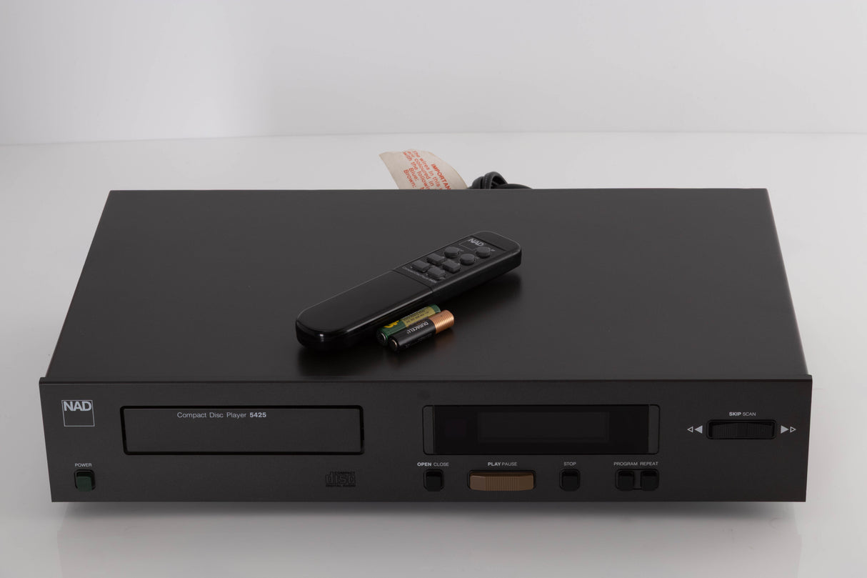 Top of a used NAD 5425 CD Player showing Remote and Batteries
