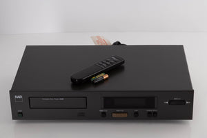 Top of a used NAD 5425 CD Player showing Remote and Batteries