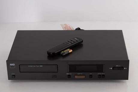 Top of a used NAD 5425 CD Player showing Remote and Batteries