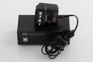Top of a used NAD PP3i Phono / USB Pre Amplifier in a Black finish showing PSU