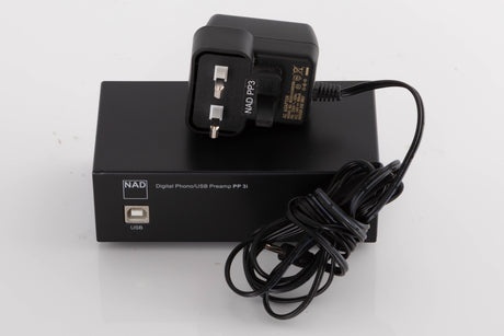 Top of a used NAD PP3i Phono / USB Pre Amplifier in a Black finish showing PSU