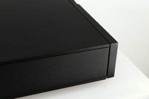 Close up of a used Naim CD5 CD Player in a black finish showing some scratches