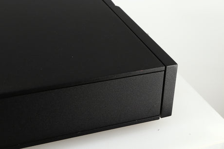 Close up of a used Naim CD5 CD Player in a black finish showing some scratches