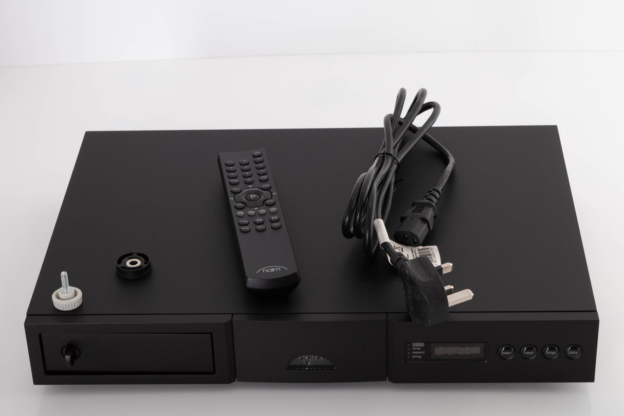 Top of a used Naim CD5 XS CD Player in a Black finish showing Remote, Batteries, CD Puck, Transit Bolt and SNAIC5
