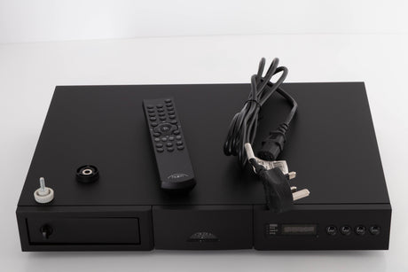 Top of a used Naim CD5 XS CD Player in a Black finish showing Remote, Batteries, CD Puck, Transit Bolt and SNAIC5