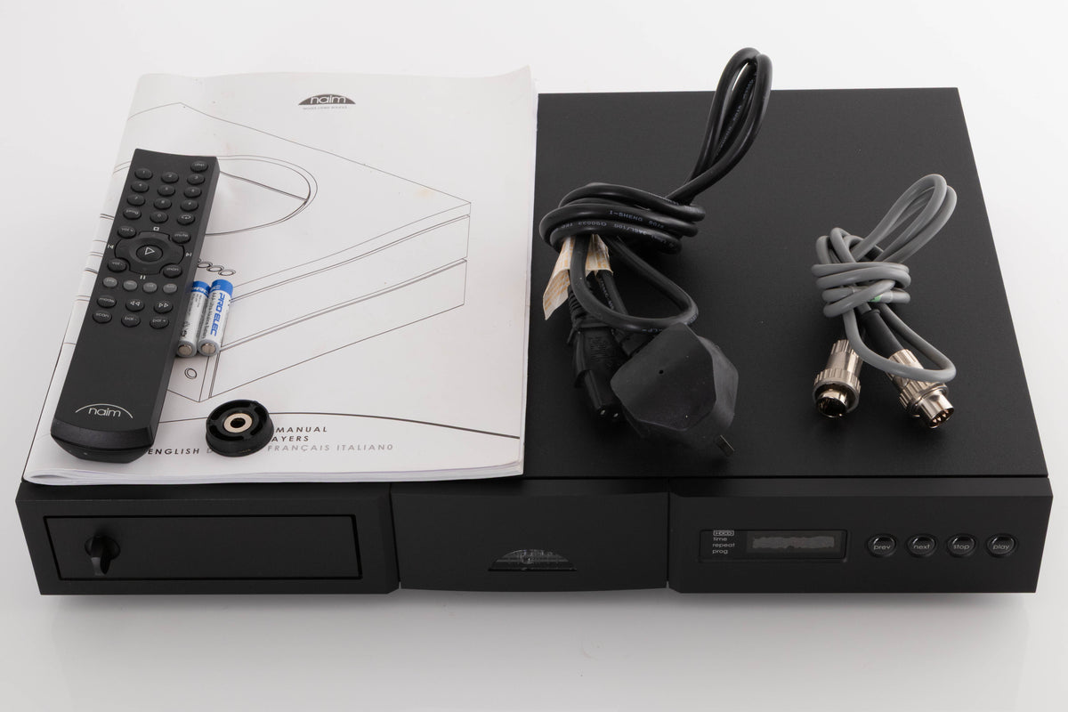 Top of a used Naim CD5 XS CD Player in a Black finish showing Mains Cable, Manual, Remote, Batteries, CD Puck and SNAIC5