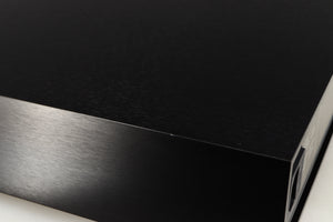 Close up of a used Naim CD555PS DR Power Supply in a black finish showing small nick on right edge
