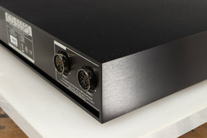 Rear left corner of a used Naim CD555PS DR Power Supply in a black finish