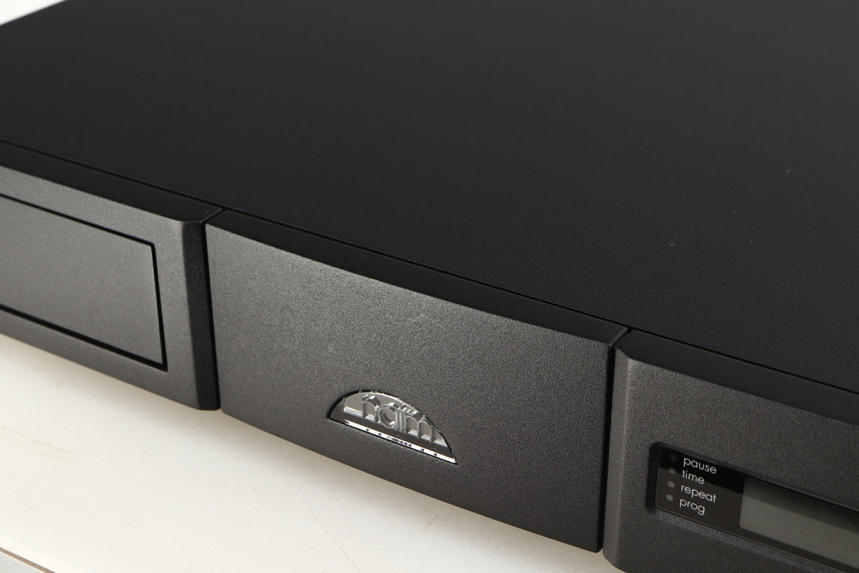 Close up of a used Naim CD5si CD Player in a black finish showing very light scratching on fascia near logo
