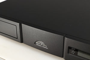 Close up of a used Naim CD5si CD Player in a black finish showing very light scratching on fascia near logo
