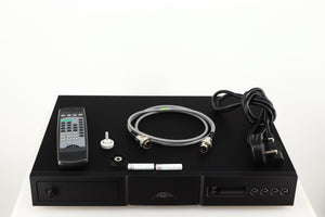 Top of a used Naim CD5X CD Player in a black finish showing Batteries, SNAIC5, Mains Cable, Remote, CD Puck and Transit Bolt