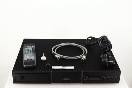 Top of a used Naim CD5X CD Player in a black finish showing Batteries, SNAIC5, Mains Cable, Remote, CD Puck and Transit Bolt