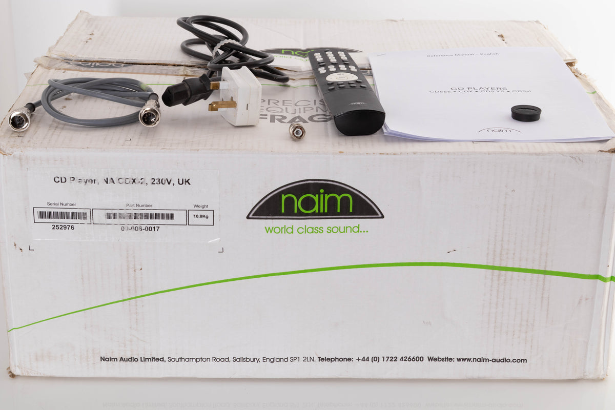 Box of a used Naim CDX2 CD Player with mains cable, remote, SNAIC, CD puck, and BNC adaptor
