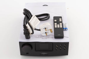 Top of a used Naim DAC V-1 Digital Analogue Converter in a Black finish showing Mains Cable, Remote, Batteries and Manual 