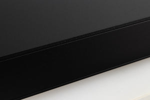 Close up of a used Naim Flatcap 2X Power Supply in a black finish showing some scratching on right side
