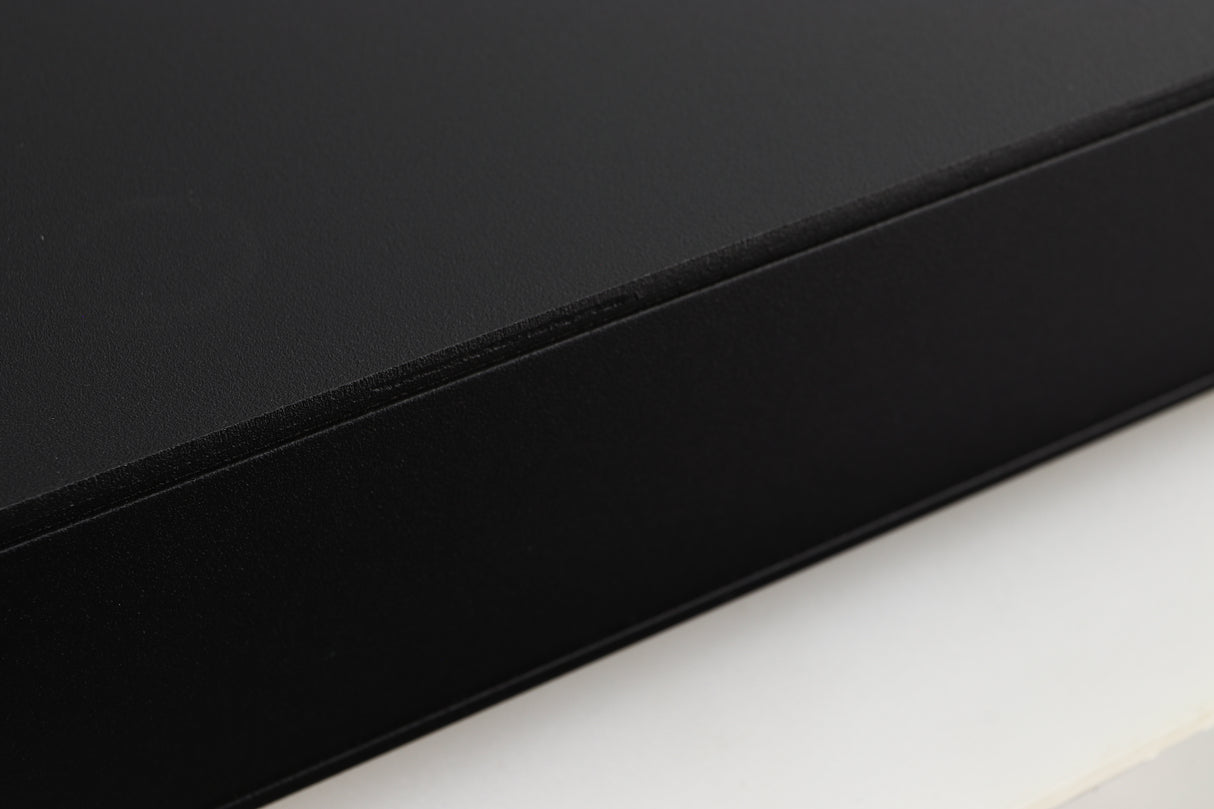 Close up of a used Naim Flatcap 2X Power Supply in a black finish showing some scratching on left side