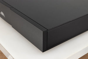 Front right corner of a used Naim Flatcap 2X Power Supply in a black finish