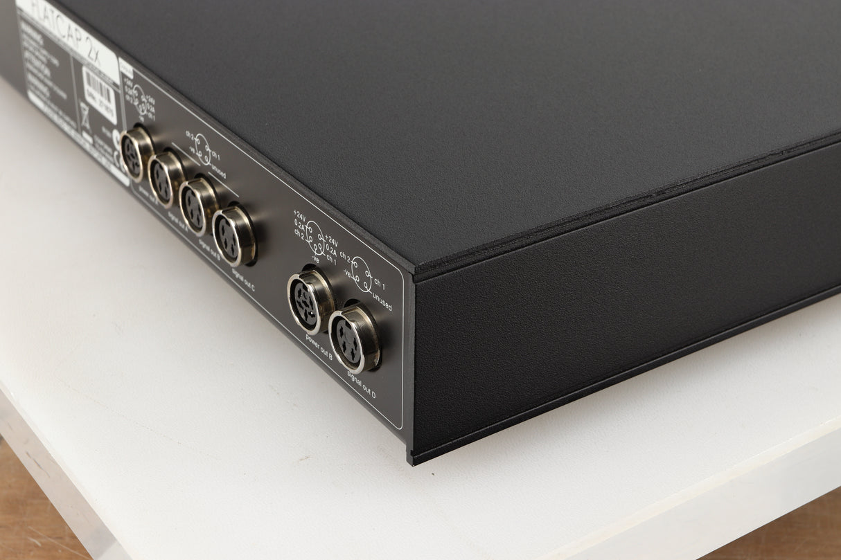 Rear left corner of a used Naim Flatcap 2X Power Supply in a black finish
