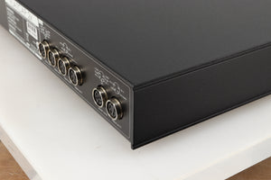 Rear left corner of a used Naim Flatcap 2X Power Supply in a black finish