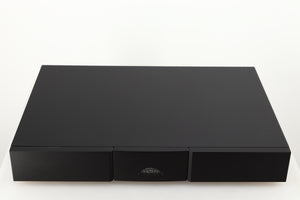 Top of a used Naim Flatcap 2X Power Supply in a black finish