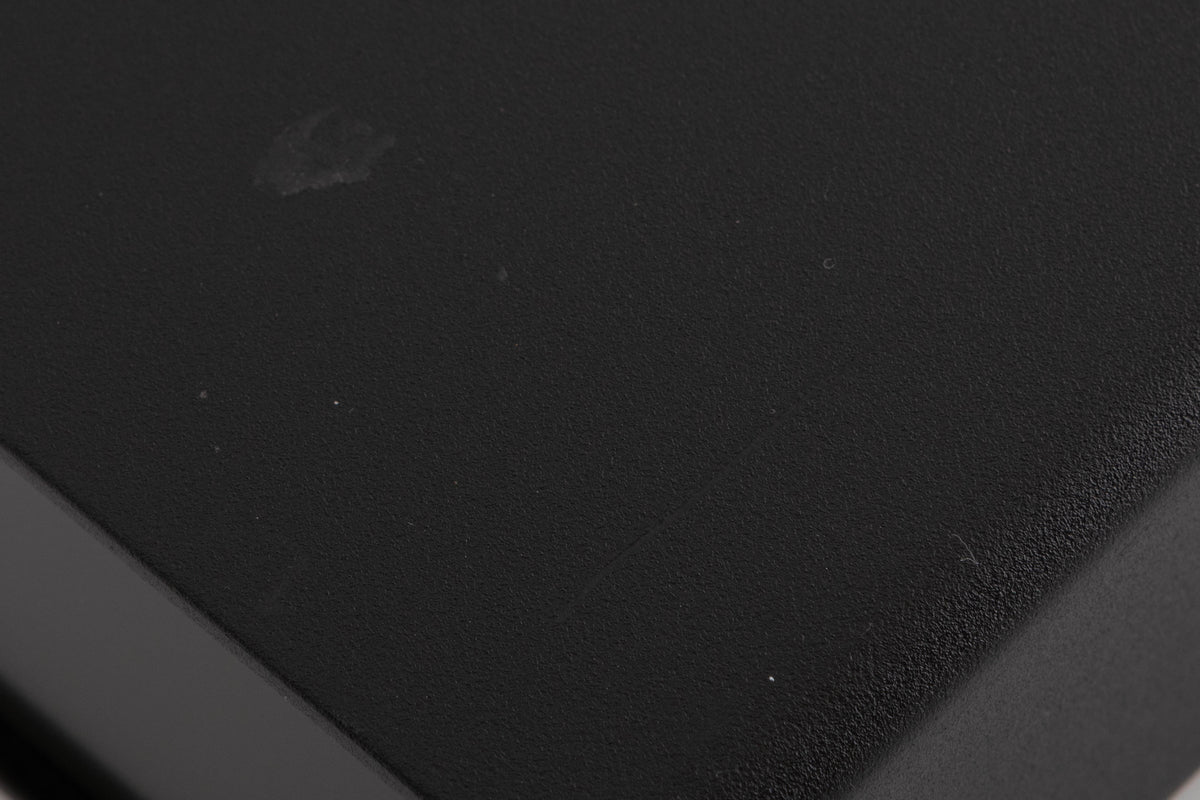 Close up of a used Naim Flatcap Power Supply in a Black finish showing mark and  scratches on top