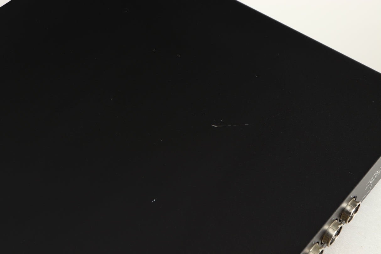 Close up of a used Naim Flatcap Power Supply in a black finish showing scratch on top