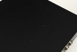 Close up of a used Naim Flatcap Power Supply in a black finish showing scratch on top