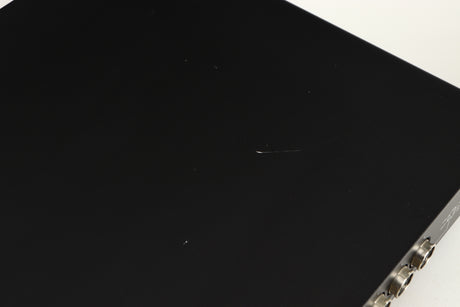 Close up of a used Naim Flatcap Power Supply in a black finish showing scratch on top