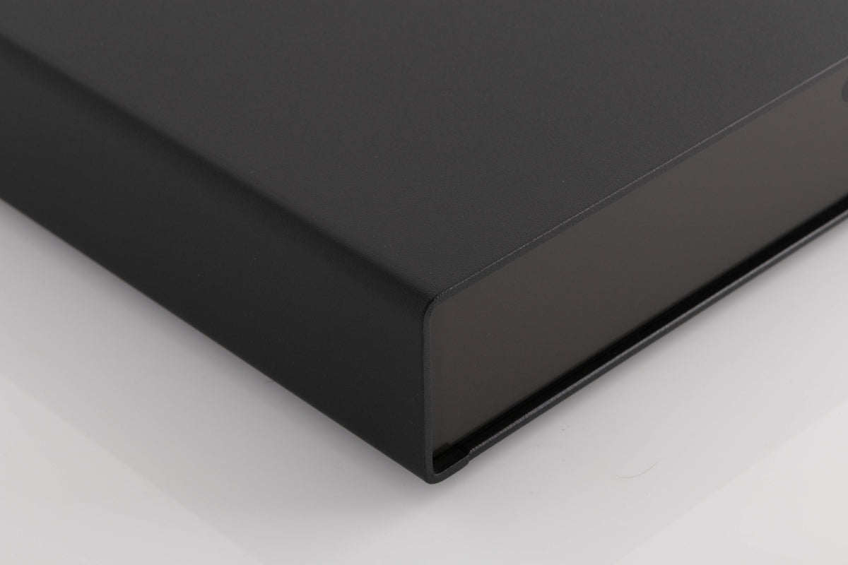 Front left corner of a used Naim Flatcap Power Supply in a Black finish