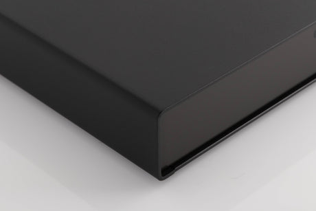 Front left corner of a used Naim Flatcap Power Supply in a Black finish