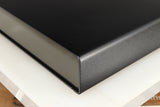 Front right corner of a used Naim Flatcap Power Supply in a black finish