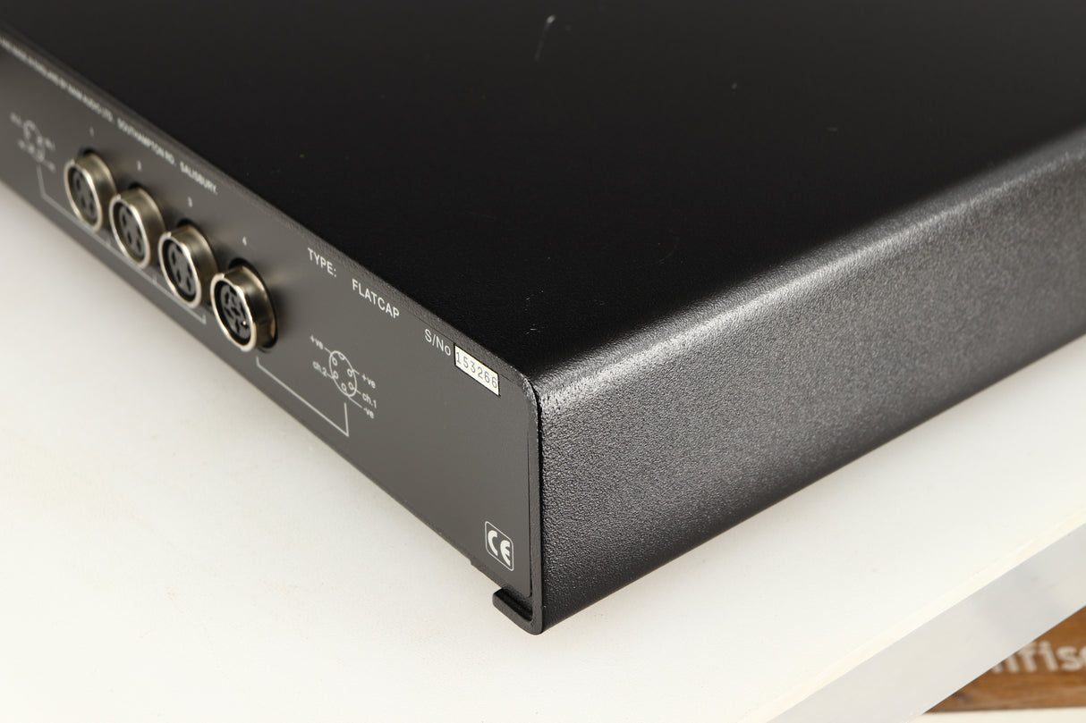 Rear left corner of a used Naim Flatcap Power Supply in a black finish