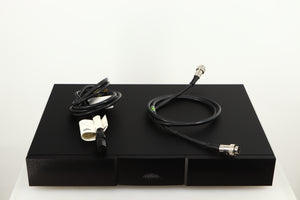 Top of a used Naim Flatcap XS Power Supply in a black finish showing Mains Cable and SNAIC5