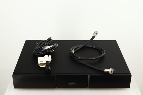 Top of a used Naim Flatcap XS Power Supply in a black finish showing Mains Cable and SNAIC5