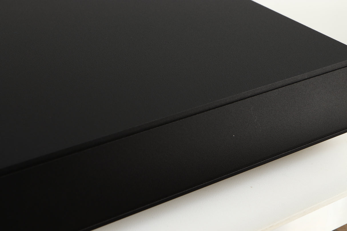 Close up of a used Naim Flatcap XS Power Supply in a black finish showing scratch on right side