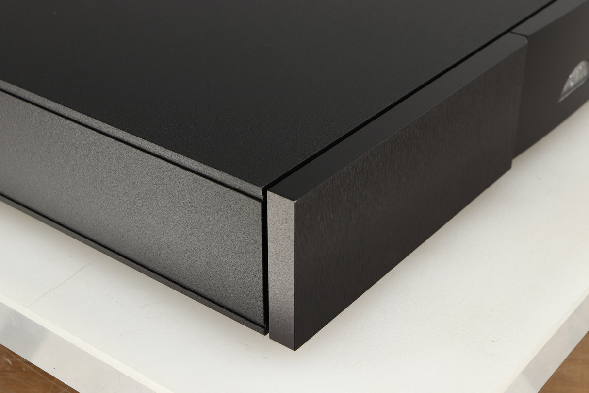 Front left corner of a used Naim Flatcap XS Power Supply in a black finish