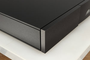 Front left corner of a used Naim Flatcap XS Power Supply in a black finish