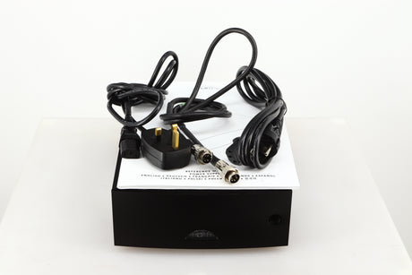 Top of a used Naim Hicap DR Power Supply in a black finish showing Manual, SNAIC5, Mains Cable and Schuko Cable