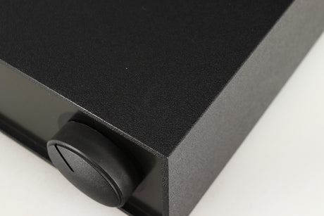 Close up of a used Naim Hicap Power Supply in a black finish showing mark on top