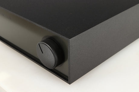 Front right corner of a used Naim Hicap Power Supply in a black finish
