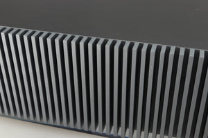 Close up of a used Naim Mu-so GEN2 Wireless Music System in a silver finish showing small graze on rear